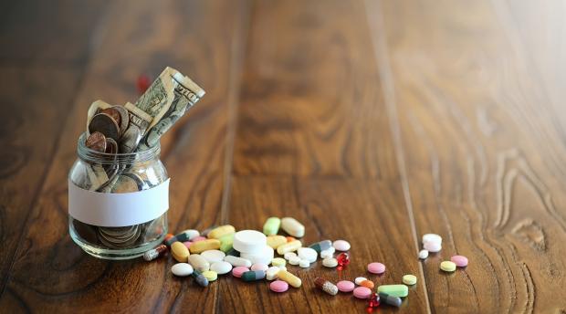 glass jar with cash, pills on table